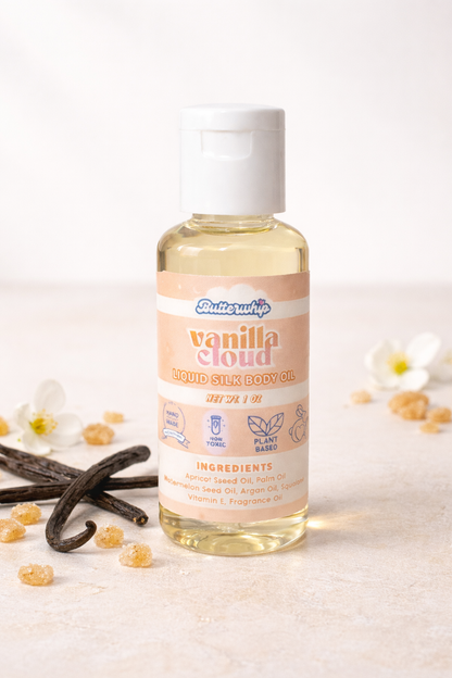 Bottle of vanilla cloud - scented similar to Vanilla 28 - body oil with vanilla beans and flowers on a light background